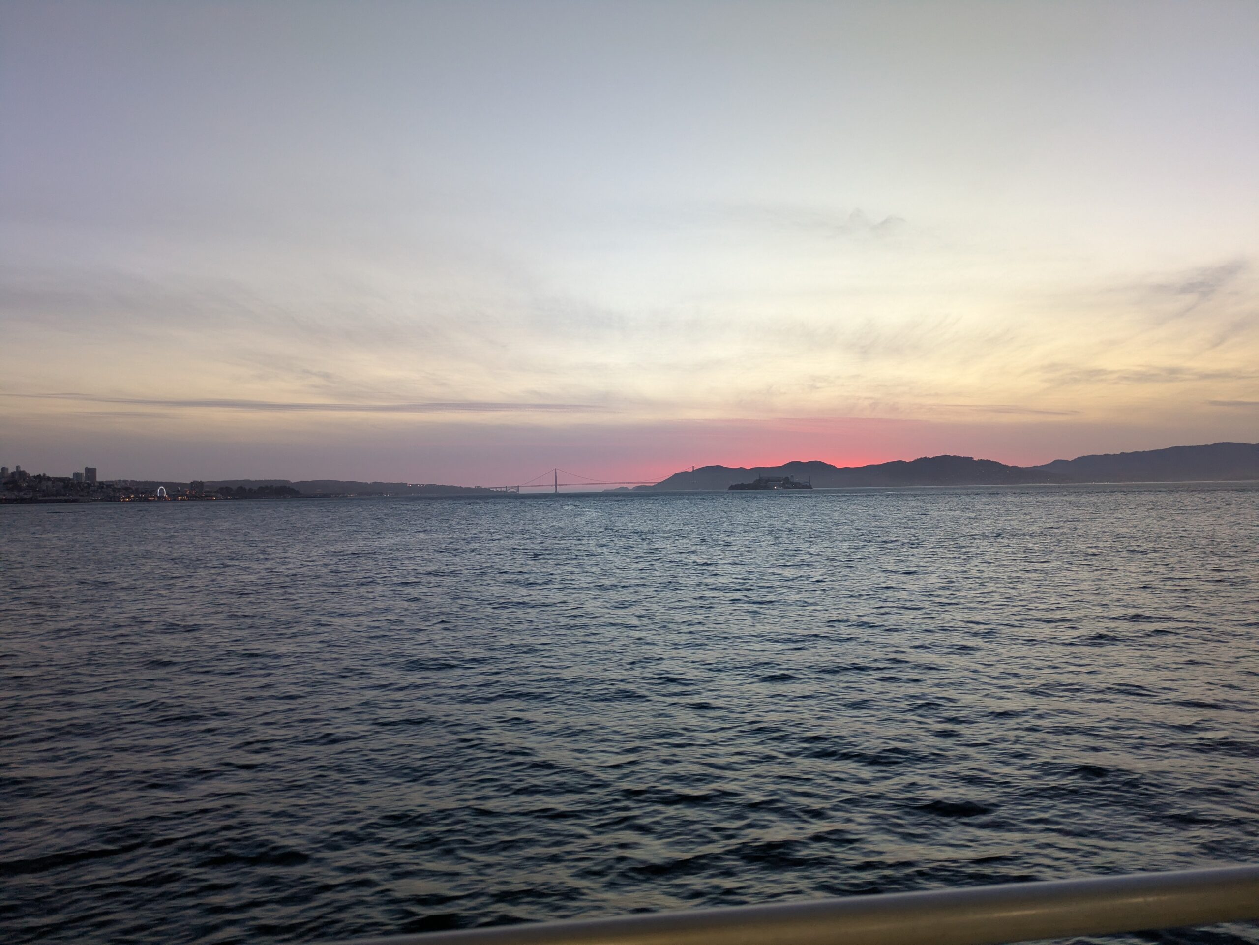 sunset over the golden gate bridge from view on sf bay ferry